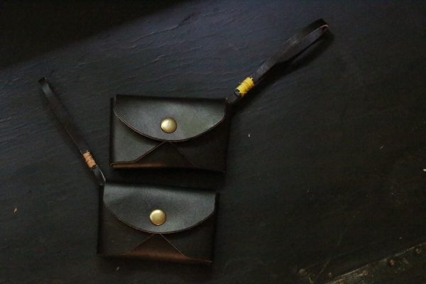 Two black leather wristlets with solid brass snap and leather strap